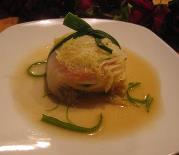 Fresh Cod lightly marinated in toasted sesame oil, shoyu, scallions and ginger wrapped in blanched napa leaf and tied with leak string -- poached in vegetable stock and served with light veg sauce and curled scallion green.